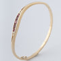 Geel gouden bangle met robijnen en briljanten