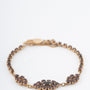 Geelgouden schakelarmband met granaten