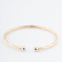 Geelgouden klem bangle met veer