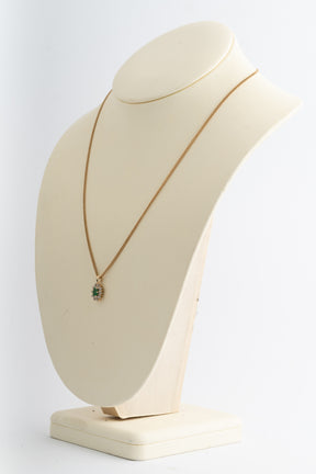 Yellow gold entourage pendant with emerald and diamonds on yellow gold gourmet necklace