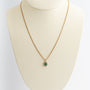 Yellow gold entourage pendant with emerald and diamonds on yellow gold gourmet necklace