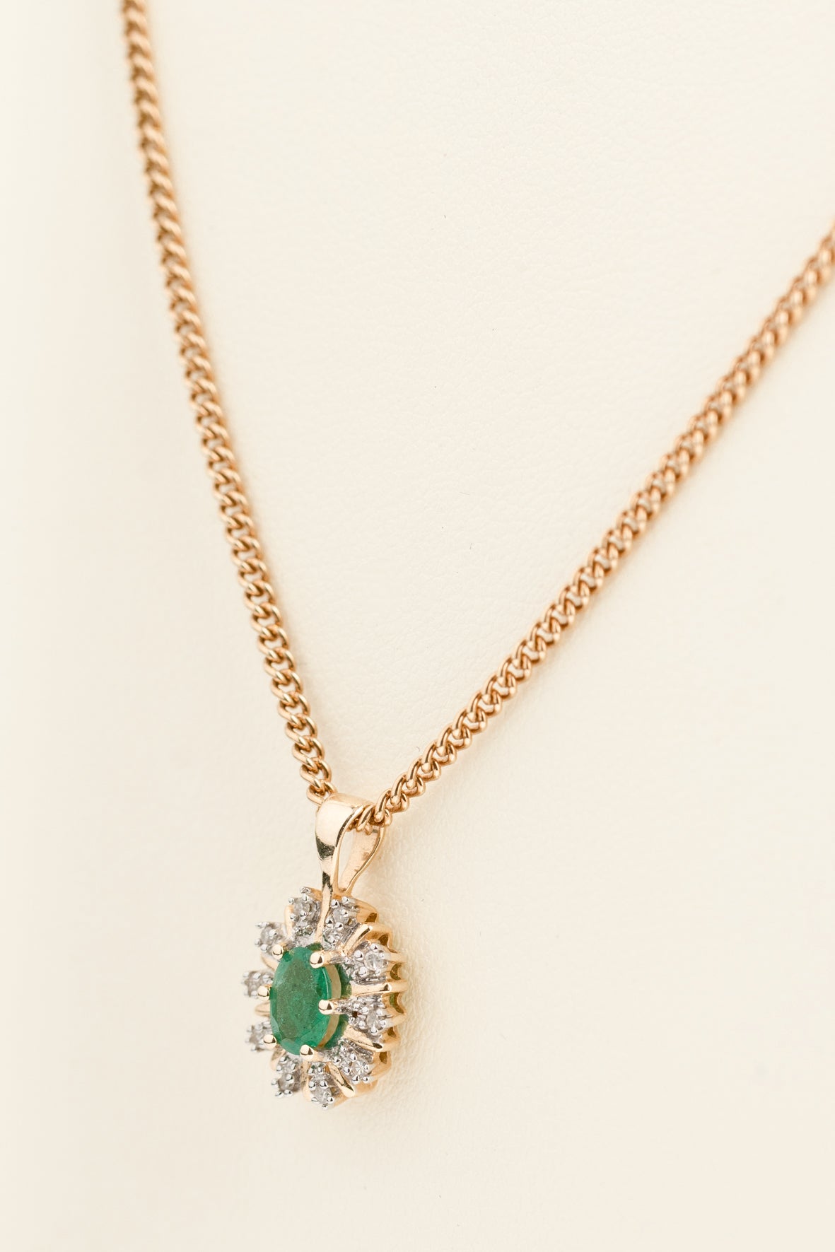 Yellow gold entourage pendant with emerald and diamonds on yellow gold gourmet necklace