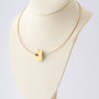 Geelgouden collier met platina hanger en bol met briljant van Niessing