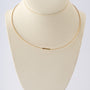Geelgouden collier met platina hanger en bol met briljant van Niessing