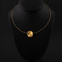 Geelgouden collier met platina hanger en bol met briljant van Niessing