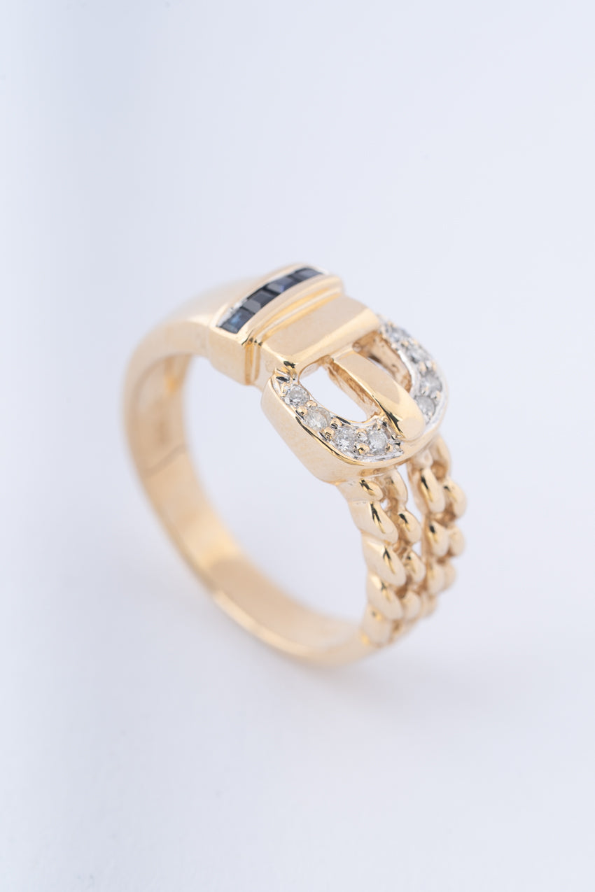 Yellow gold buckle ring with brilliant cut diamonds and square cut sapphires