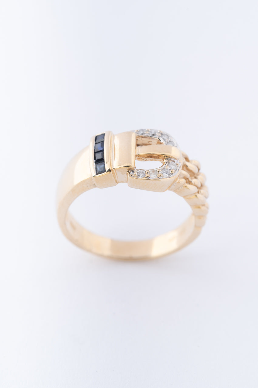 Yellow gold buckle ring with brilliant cut diamonds and square cut sapphires
