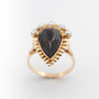 Yellow gold ring with pear-shaped garnet and pearls