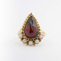 Yellow gold ring with pear-shaped garnet and pearls