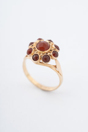 Yellow gold entourage ring with carnelian