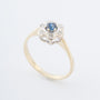 Yellow gold entourage ring with sapphire and brilliant-cut diamonds