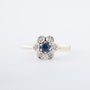 Yellow gold entourage ring with sapphire and brilliant-cut diamonds