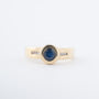Yellow gold band ring with a sapphire and brilliant-cut diamonds
