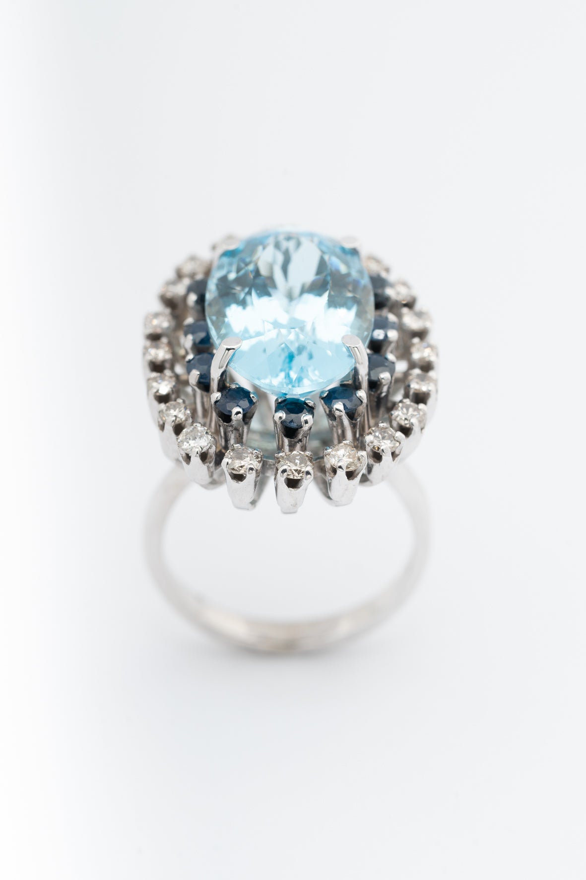 Wit gouden dubbele entourage ring met topaas, saffieren en briljanten.