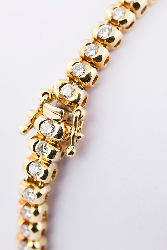 Yellow gold tennis bracelet with diamonds