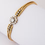 Yellow gold entourage bracelet with brilliant