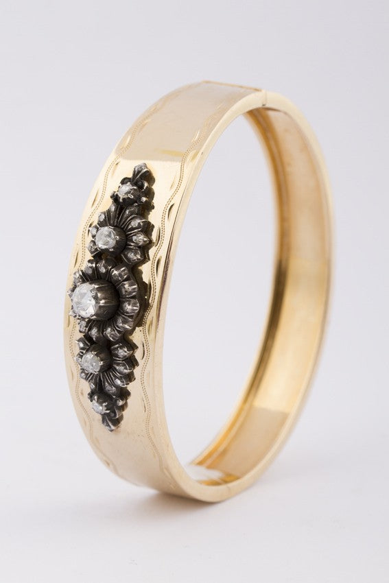Gold stiff bracelet with silver applique with diamonds