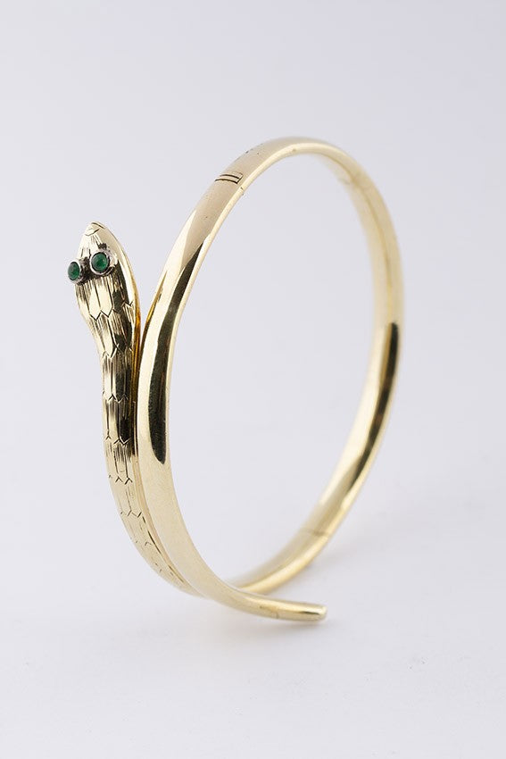 Gold snake slave bracelet with emeralds