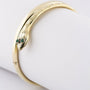 Gold snake slave bracelet with emeralds