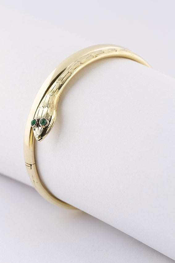 Gold snake slave bracelet with emeralds