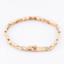 Gold link bracelet with diamonds.