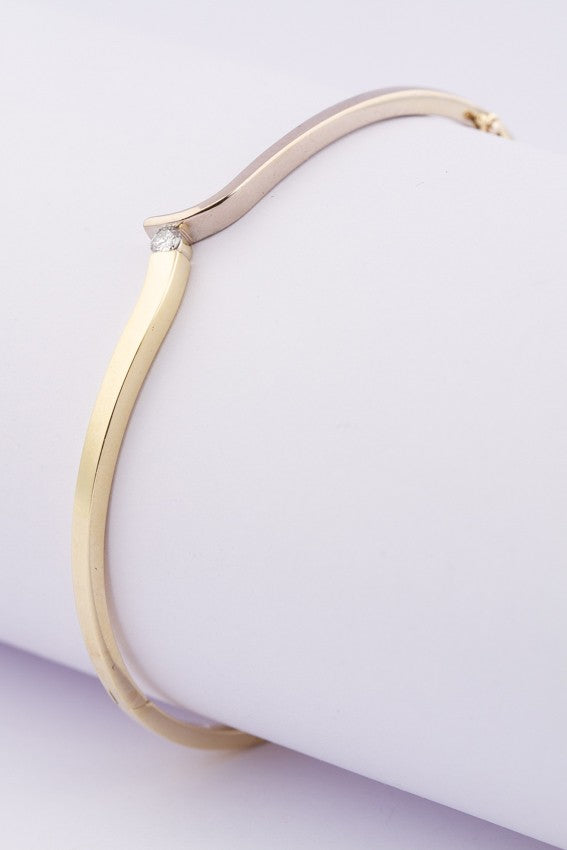 White/yellow gold hinged slave bracelet with a brilliant