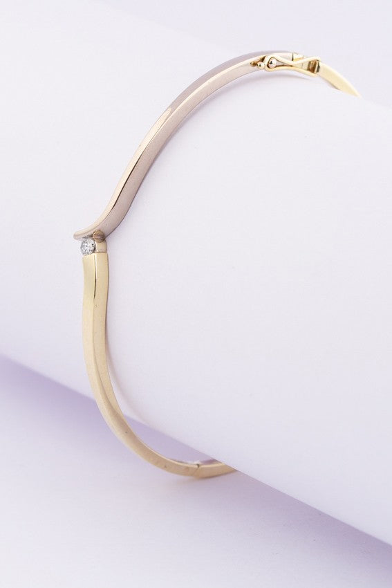 White/yellow gold hinged slave bracelet with a brilliant