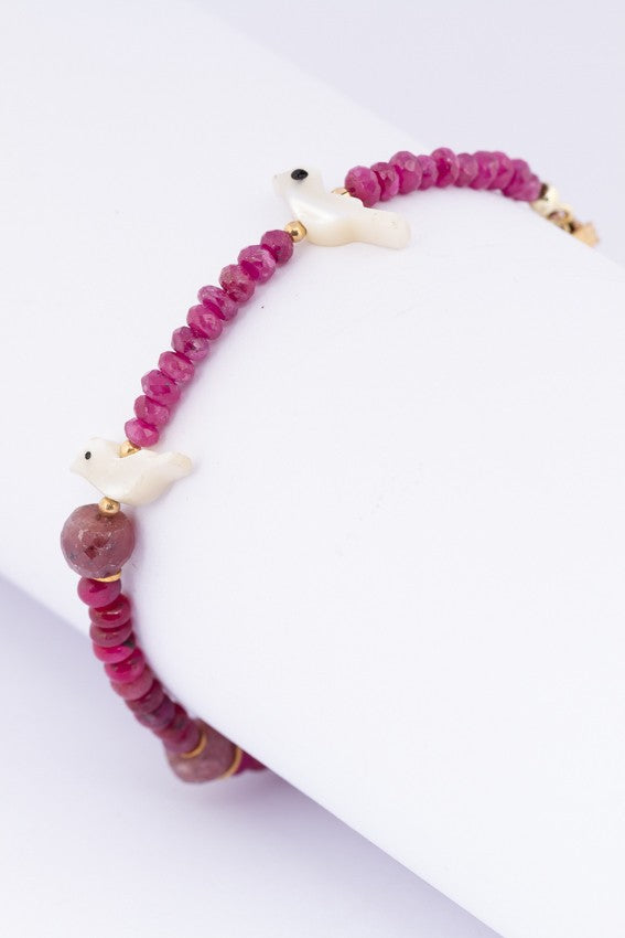 Ruby bracelet with gold charms