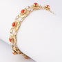 Gold link bracelet with blood corals