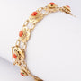 Gold link bracelet with blood corals
