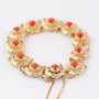 Gold link bracelet with blood corals