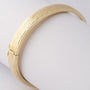 Gold bangle with hinged closure