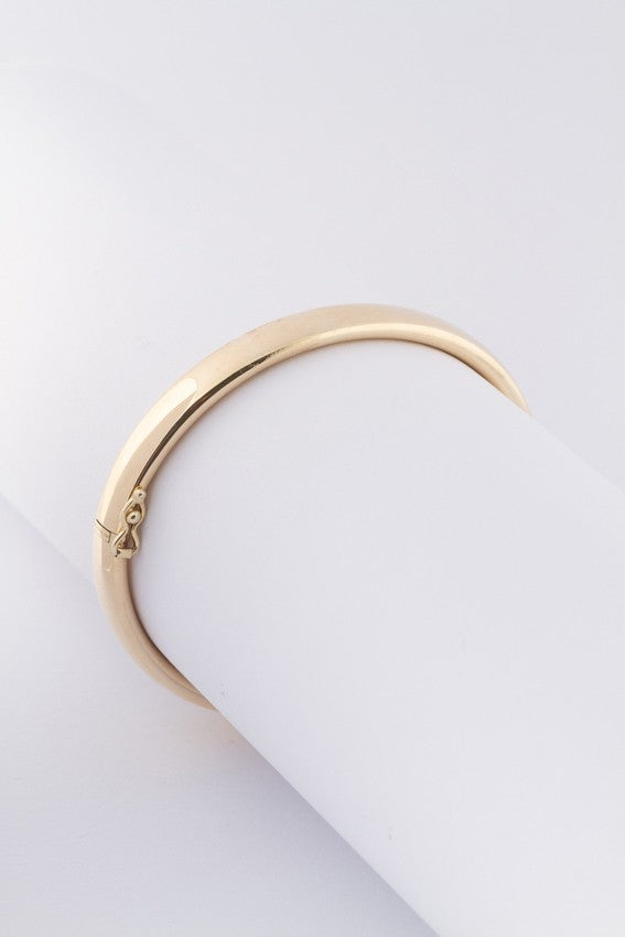 Gold bangle with silver core tube with hinged closure