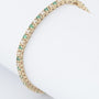 Gold tennis bracelet with emeralds and diamonds