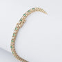 Gold tennis bracelet with emeralds and diamonds
