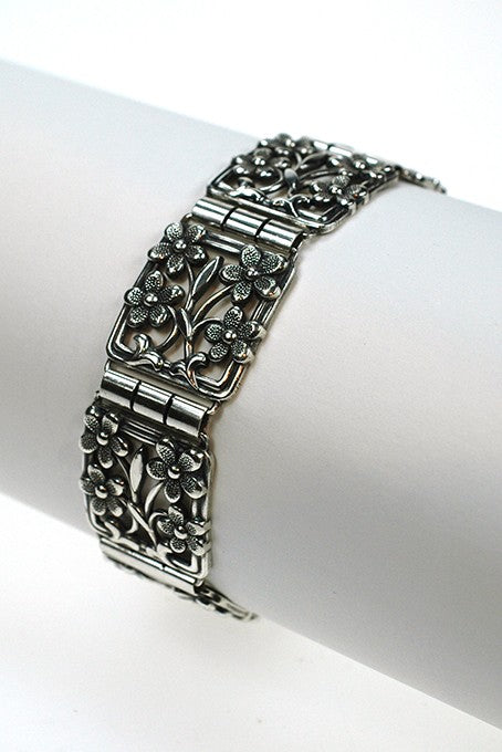Silver bracelet with floral motifs.