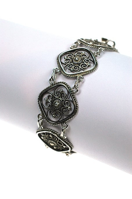Silver filigree link bracelet.