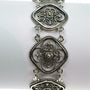 Silver filigree link bracelet.
