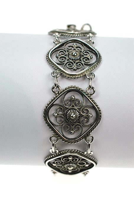 Silver filigree link bracelet.