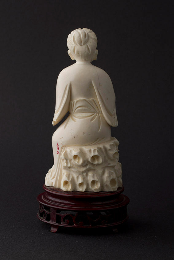 Old ivory sculpture of a man with a money bag and ruji