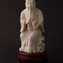 Old ivory sculpture of a man with a pipe