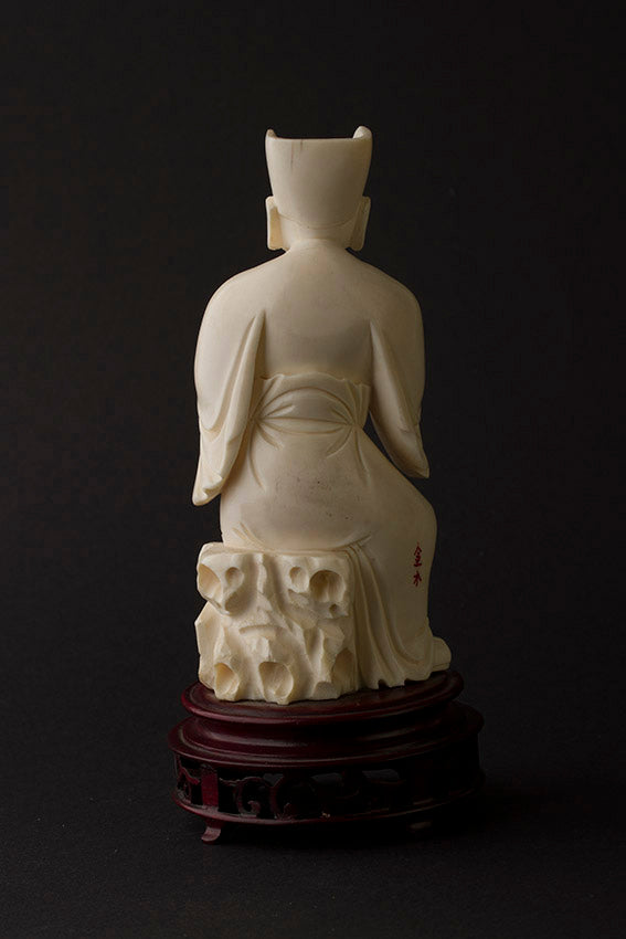 Old ivory sculpture of a man with a pipe