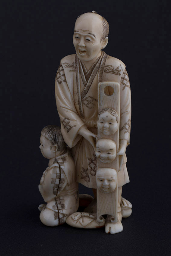Antique ivory okimono, so-called mask seller