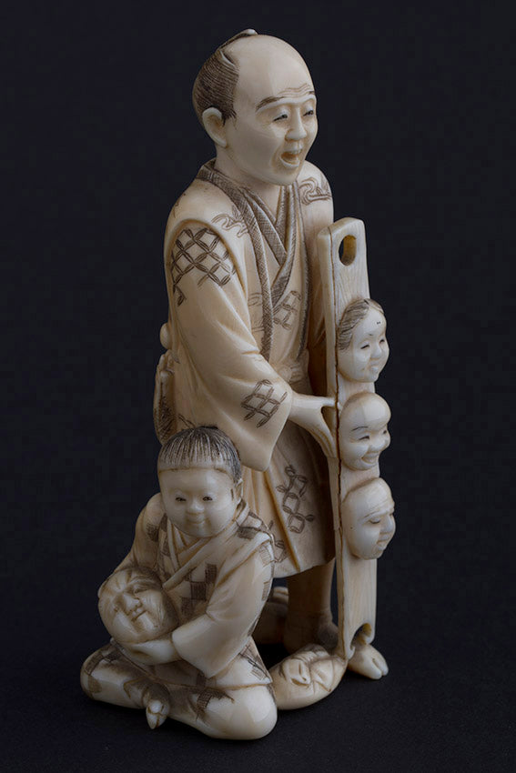 Antique ivory okimono, so-called mask seller