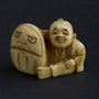 Antique ivory netsuké man with Darma doll