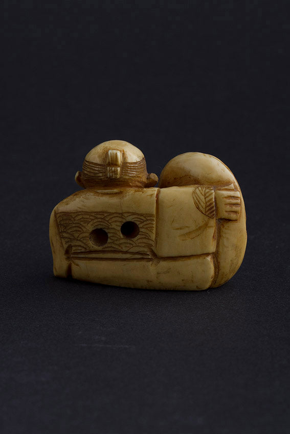 Antique ivory netsuké man with Darma doll