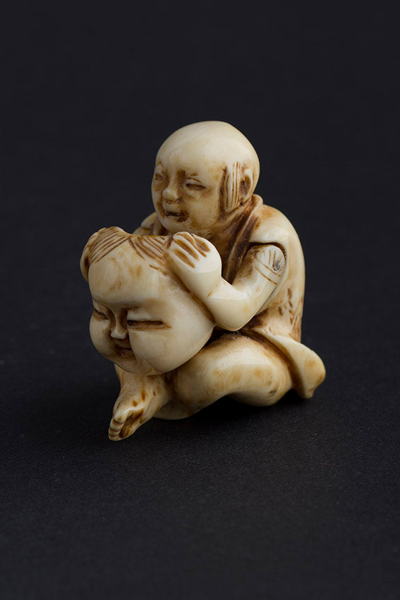 Antique ivory netsuké man with moving mask