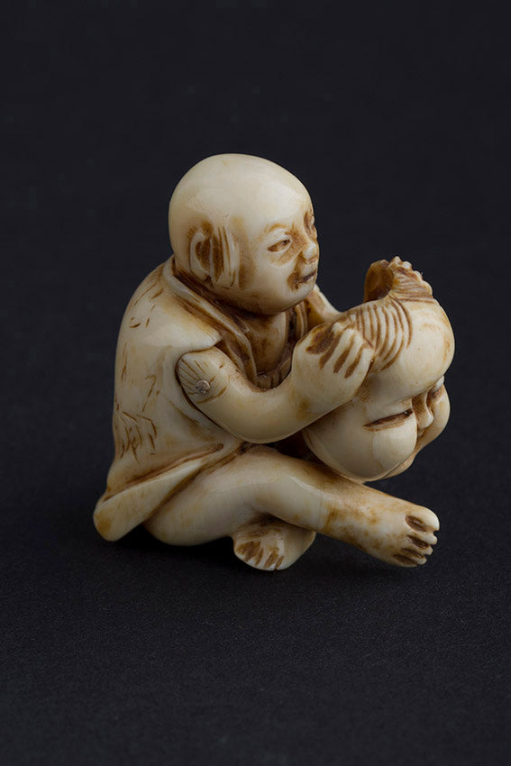 Antique ivory netsuké man with moving mask
