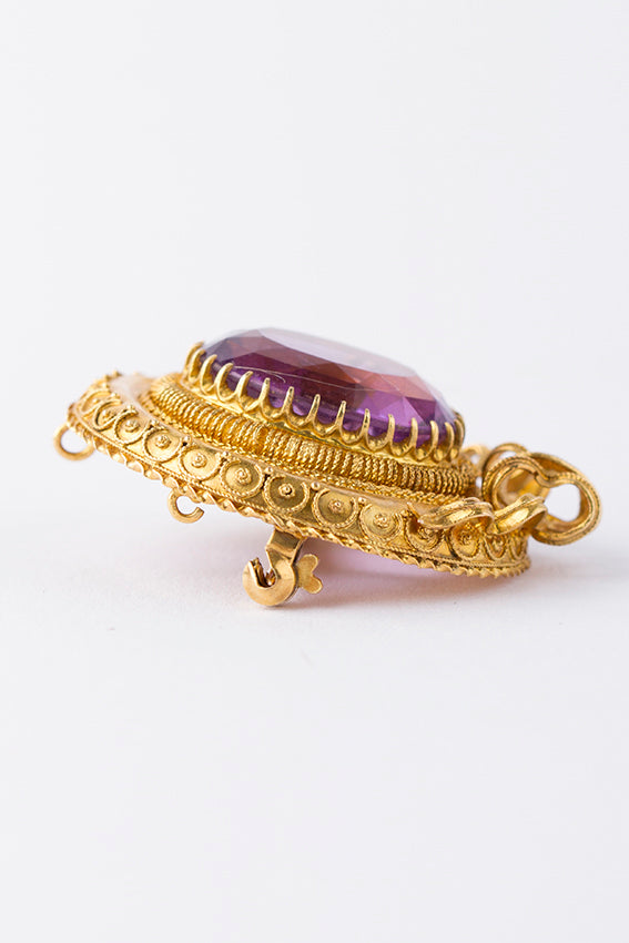 Antique gold brooch with amethyst