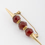 Golden skewer with carnelian